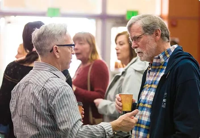 People gathering in the lobby of The Local Vineyard Church in Midlothian