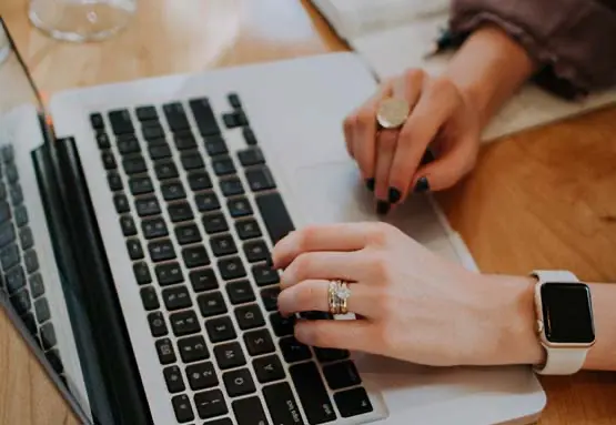 Woman typing on a laptop demonstrating online giving