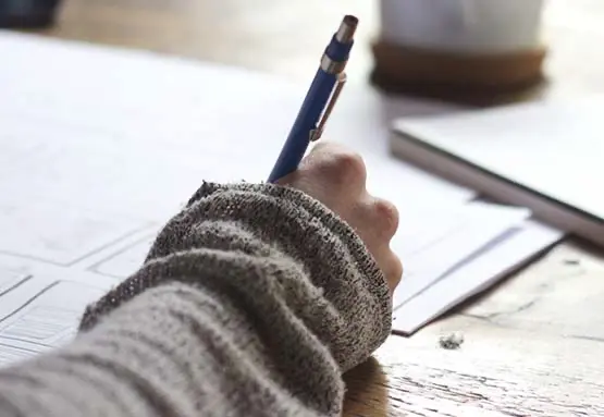 Woman writing a check.