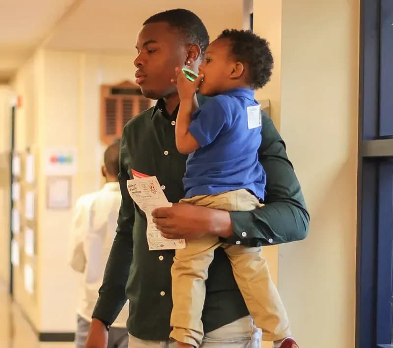 A father and son checking in at The Local Vineyard Church.