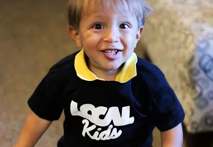 A preschool child smiling at the camera