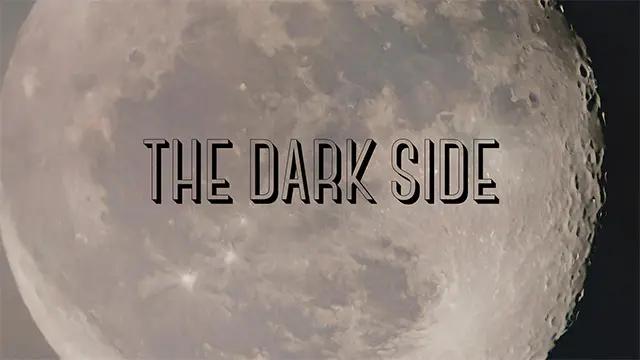 A picture of the moon with "the dark side" written over it.